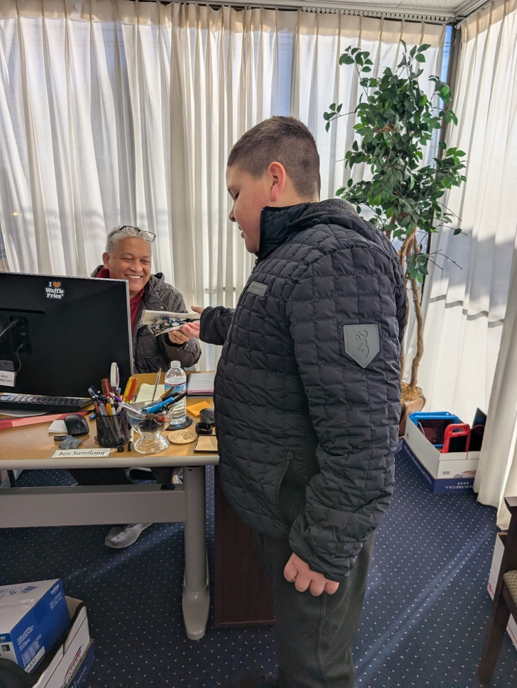 A student delivering a goody bad to a DPS employee 