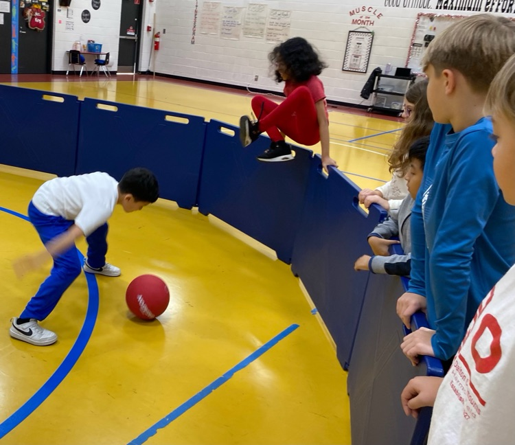 A student jumps just in time to avoid getting hit by the ball!