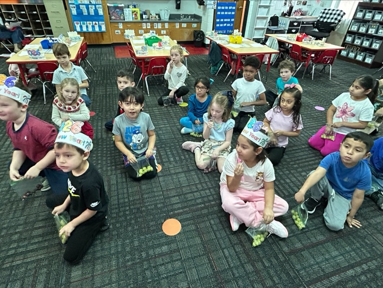 A group picture of the students with their grapes