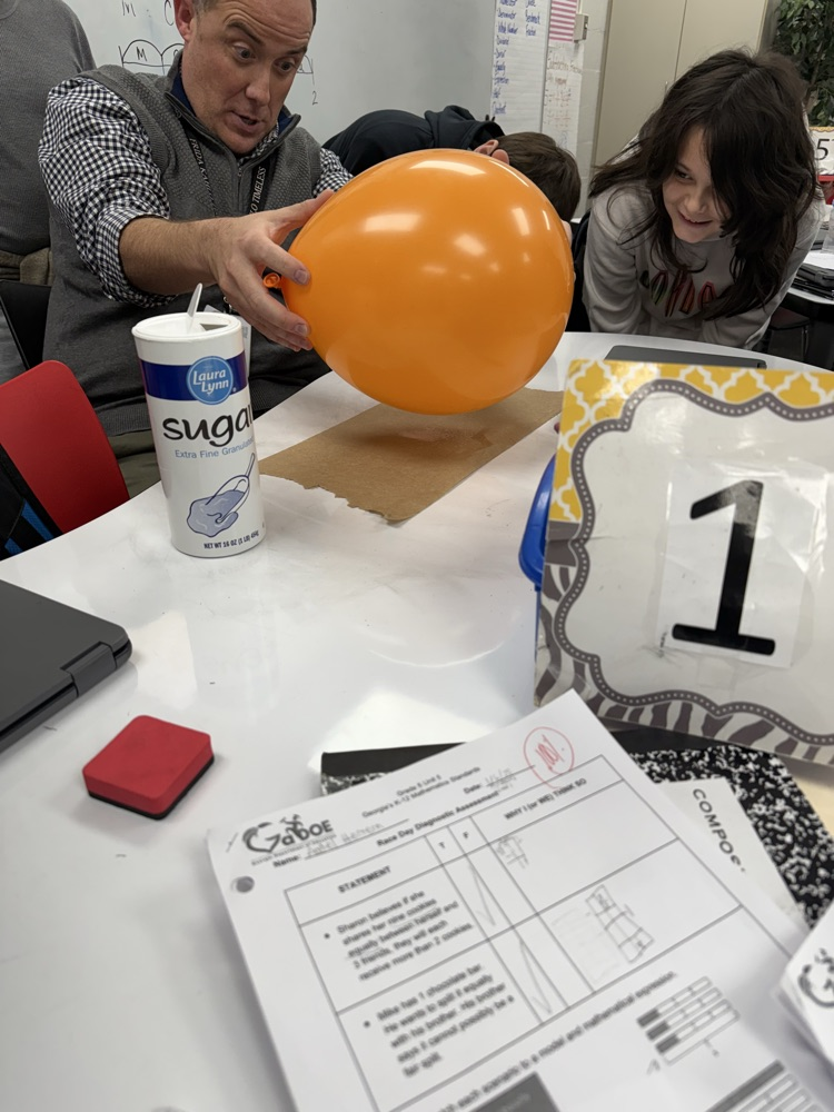 students conduct science experiment