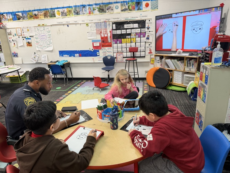 Officer Johnson drawing with the students 