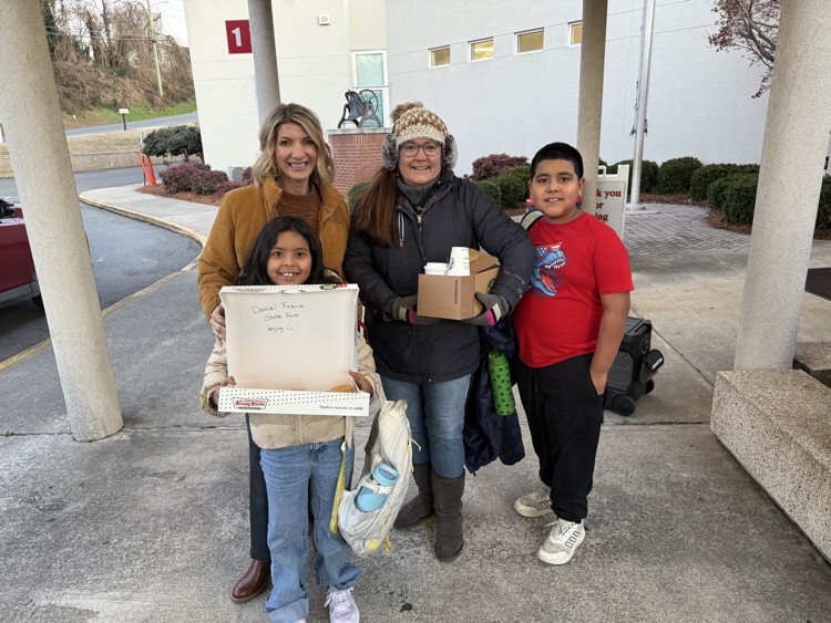 Mrs. Smith and Mrs. Ulman with the students bringing coffee and donuts 