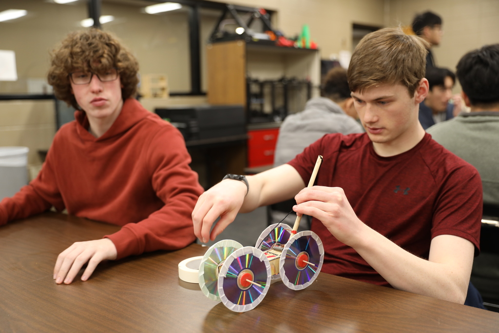 CTAE Month highlight ⚙️🚗 Engineering and Technology students at Dalton High School, led by instructor Paul White, are applying problem-solving, design, and critical-thinking skills through hands-on projects. In these photos, students are designing and building mousetrap cars using 3D-printed and laser-cut components of their own creation—testing their designs for speed or distance while learning the engineering design process in action. #CTAEMonth