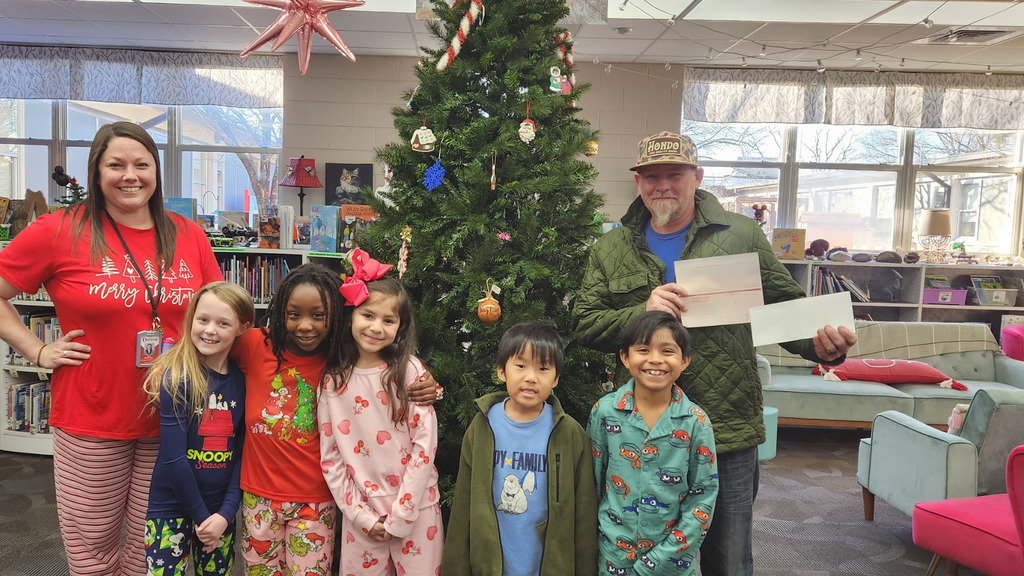 students and teachers donating profits from dog treat sale