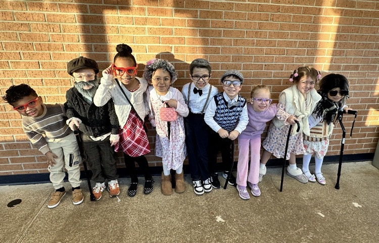 Kindergarten students dressing up as 100 years old person 