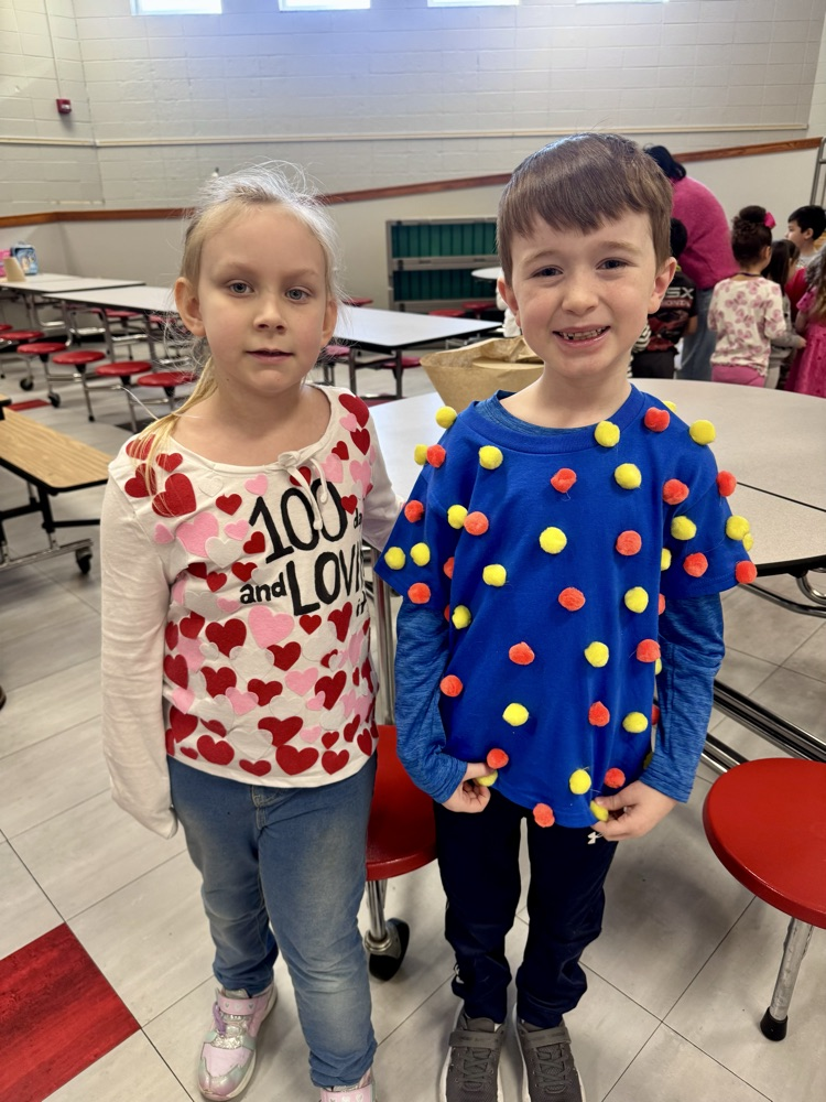 Students with 100 Pom Poms and hearts on their shirts  