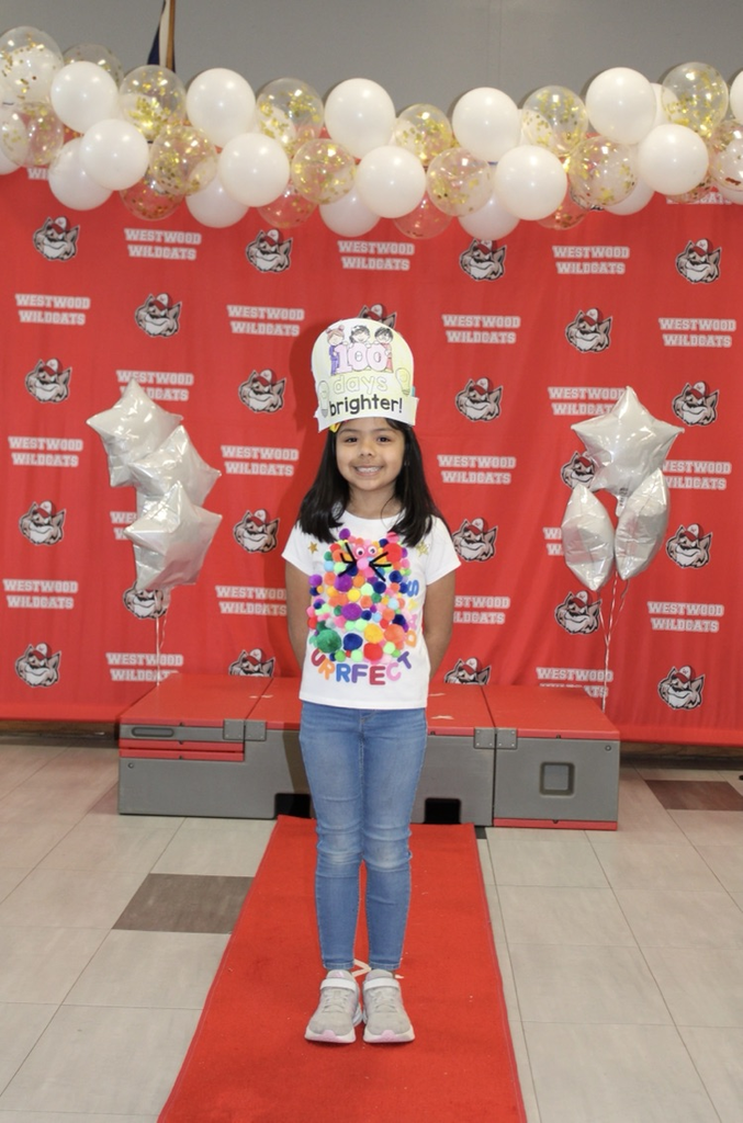 A Student with 100 Pom poms on her shirt 