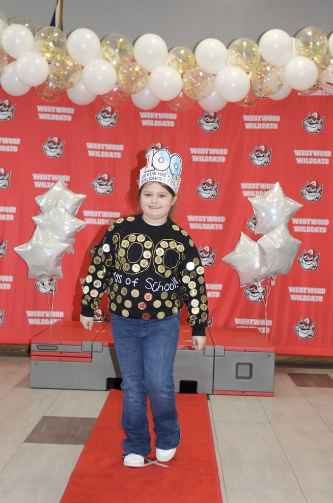 A student with 100 coins on her shirt 
