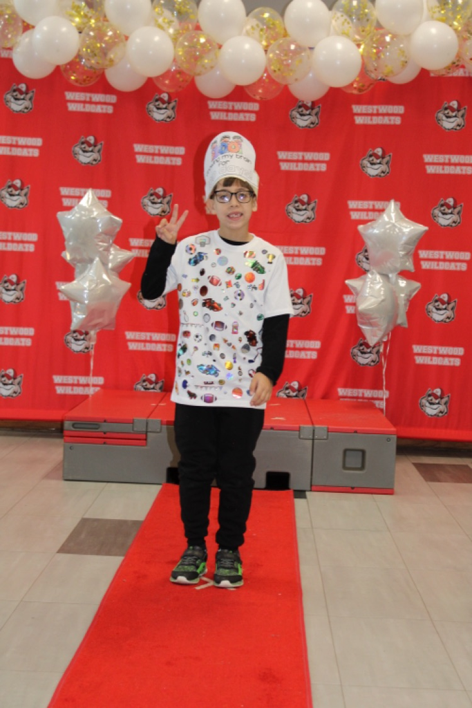 A student with 100 stickers on his shirt 