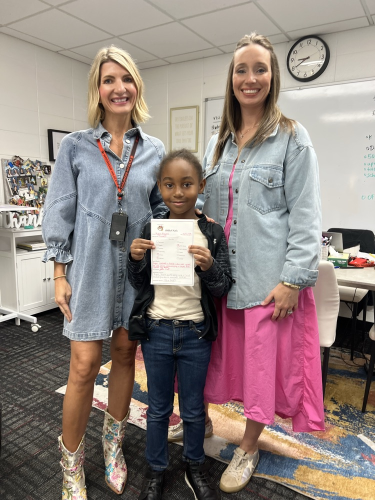 Mrs. Smith and Mrs. Ridley with a student 