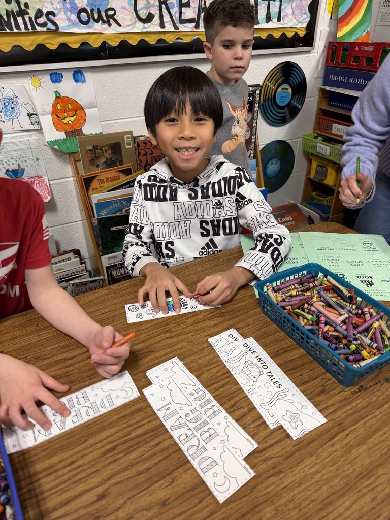 A student coloring a bookmark 