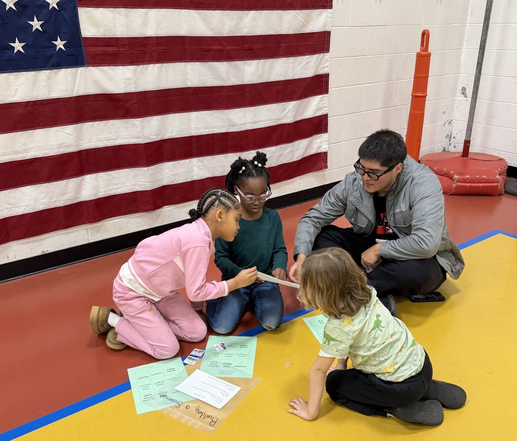 Students and a Dad enjoying a literacy activity