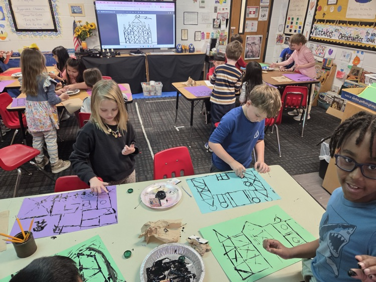 Students working on drawings using a black ink technique 