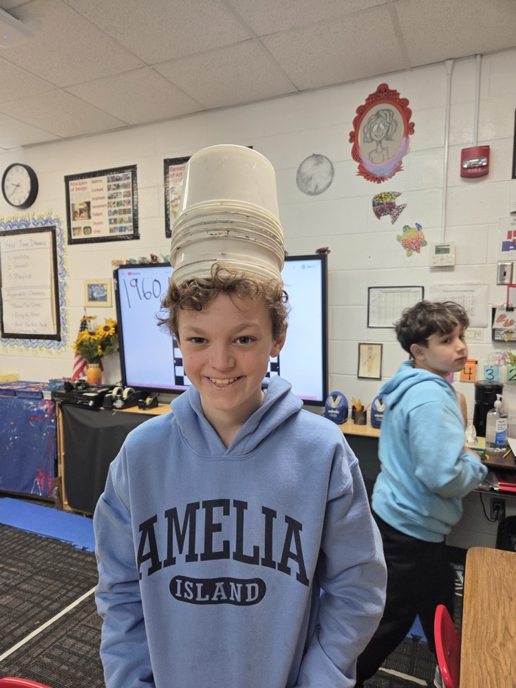 Student being funny wearing some buckets on his head 