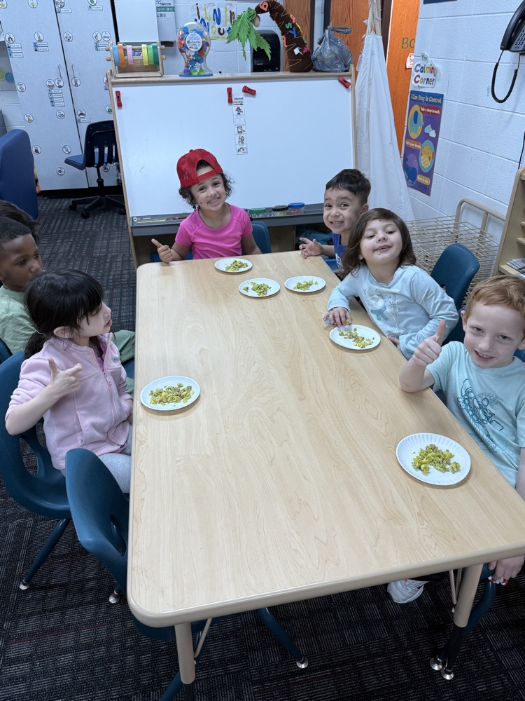 Students giving thumbs up to green eggs and ham 