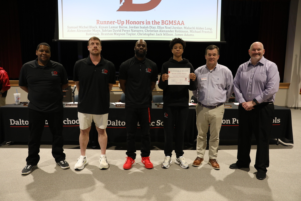 During the March 9 Board of Education meeting, Dalton Public Schools recognized student achievements, staff leadership, and community excellence across the district while also celebrating School Board Appreciation Month with a special presentation honoring the Dalton Board of Education.  The Board recognized the Middle School Varsity Basketball Team for earning BGMSAA Runner-up honors, and the Dalton High School Game Day Cheer Team for qualifying for the 2026 State Tournament. The Board also honored Dalton High School senior Angela Ramirez-Ramirez for being named a QuestBridge National College Match Scholar, and student-athletes from Dalton Junior High School and Hammond Creek Middle School who were selected for the Georgia Middle School All-Star Basketball Team.  In addition, the Board recognized Jeff Wells for his leadership in guiding all 10 Dalton Public Schools to earn the Ready Georgia Seal of Preparedness. Students from Dalton High School were also honored for their work featured in the Hunter Museum Teen Art Show, including Giselle Nunez, Aaron Augustine, and Sulema Morales, whose artwork earned recognition and awards.  The Board also celebrated Dr. Steven Craft for being named a 2025–2026 Superintendent to Watch by the National School Public Relations Association (NSPRA).  The Board congratulates all honorees for their dedication, talent, and commitment to excellence in Dalton Public Schools.