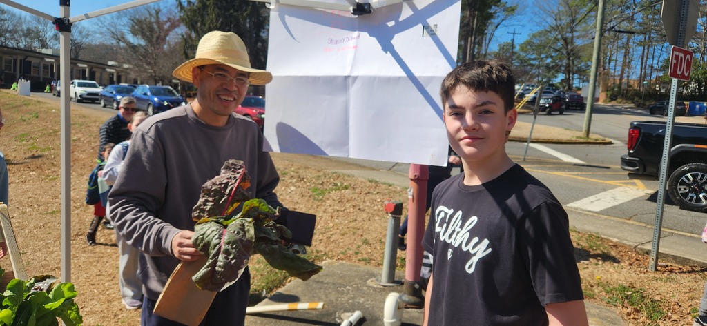 students working at the farmers market