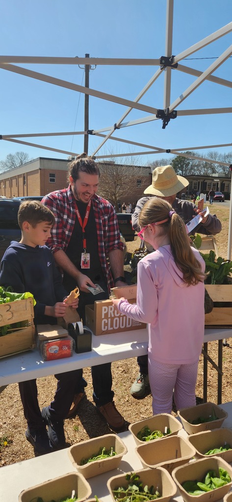 students working at the farmers market