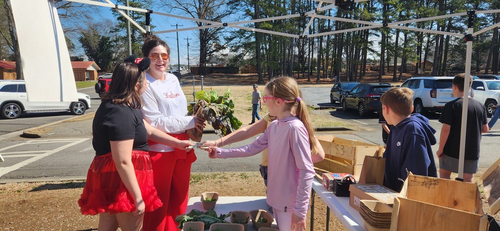 students working at the farmers market
