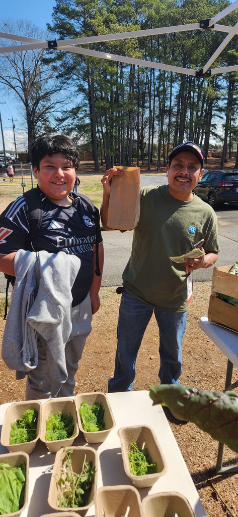 students working at the farmers market