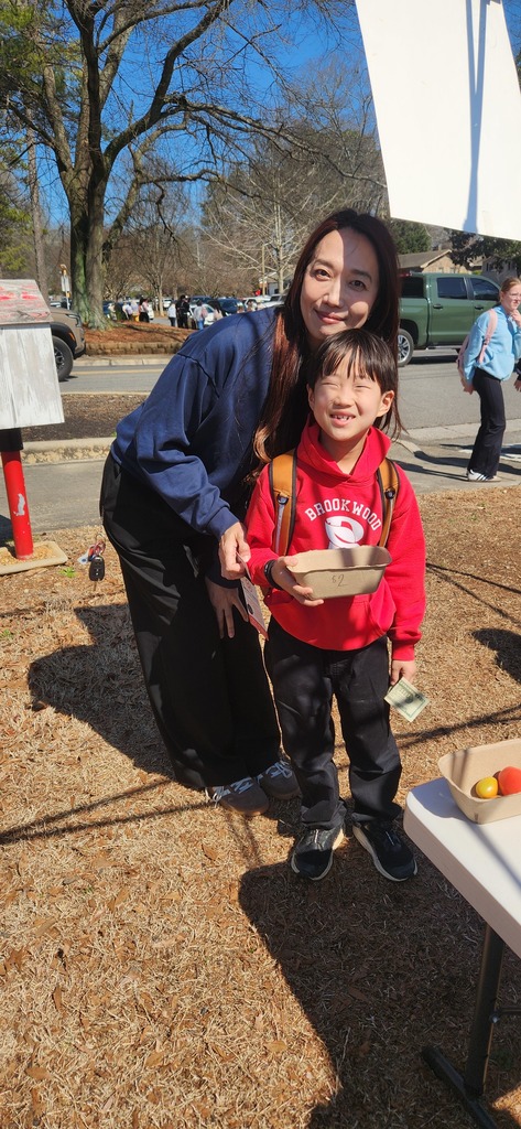 students working at the farmers market