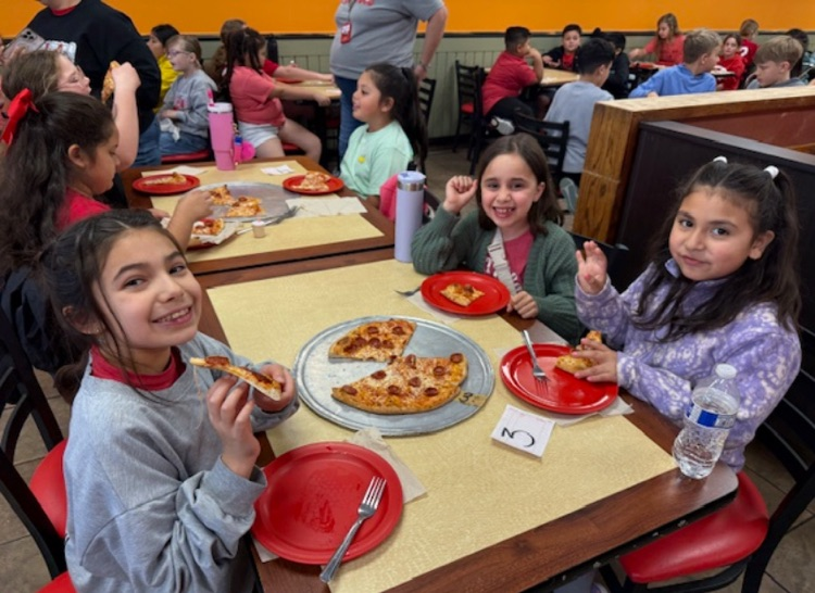 Students enjoying the pizza they made 