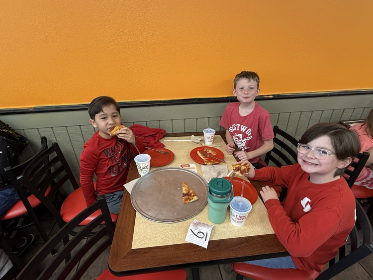 Students enjoying the pizza they made 