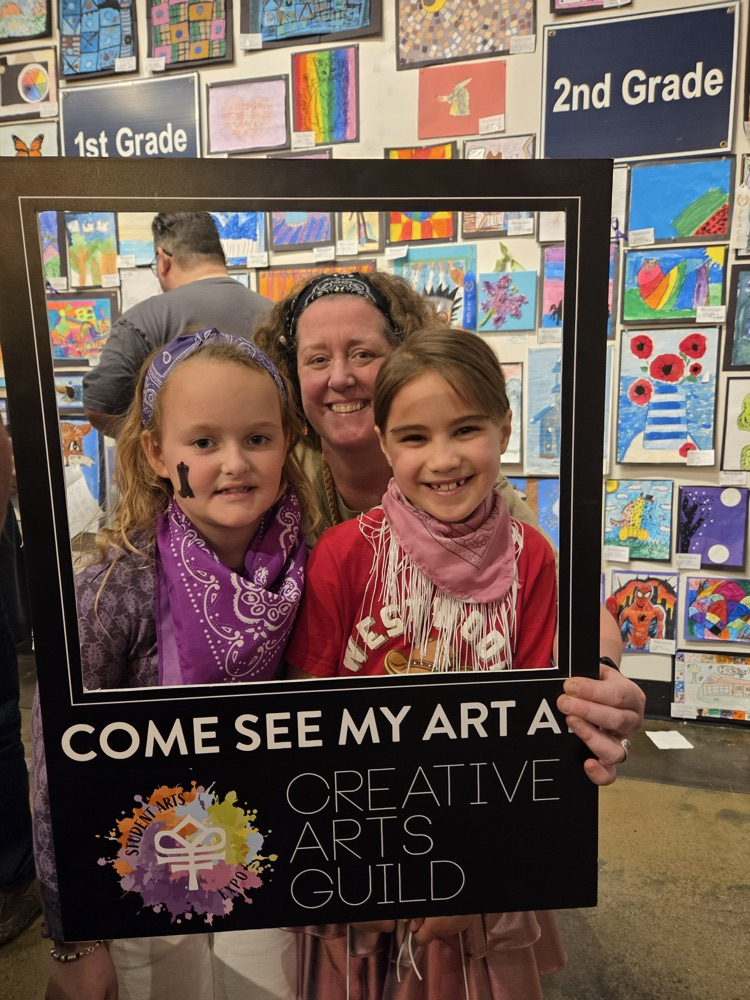 Mrs.Walker taking a picture with 2 students 