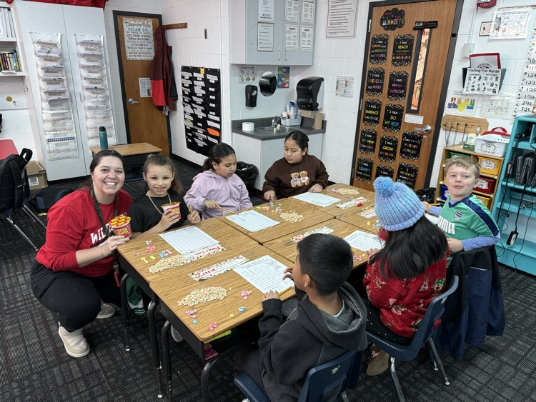 Mrs. Holmes taking a picture with a group of students