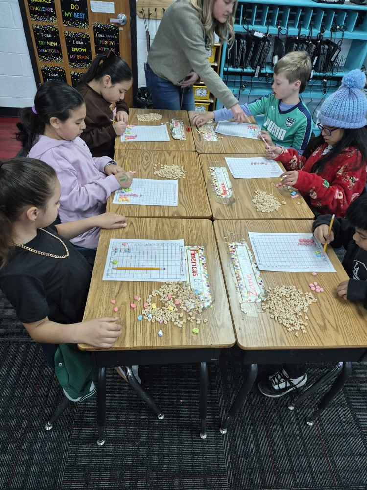 Mrs. Scoggins explaining the task to one of the students 