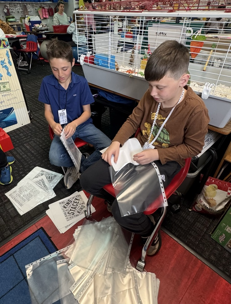 Student organizing papers for a teacher 