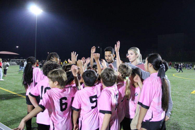 Soccer team huddling up after the game
