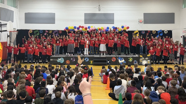 A group picture performing for the younger grades