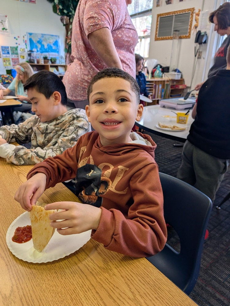 Student enjoying his quesadilla