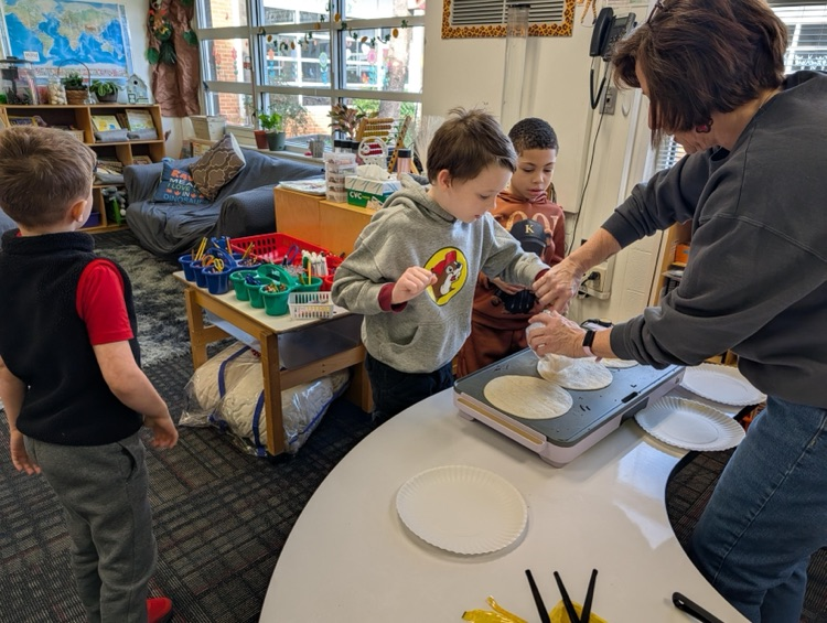Student putting cheese on his tortilla