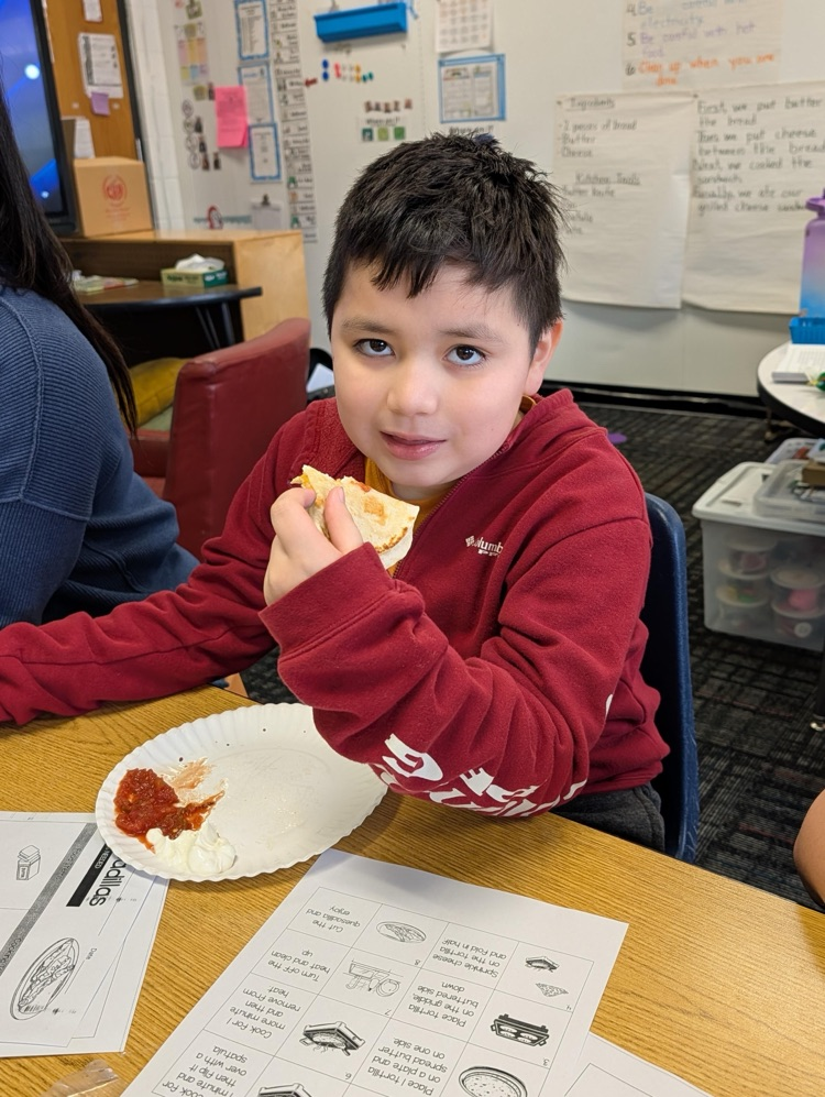 Student enjoying his quesadilla