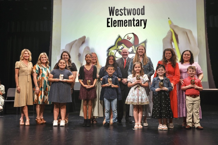 A picture of the students and teachers on stage during the awards ceremony