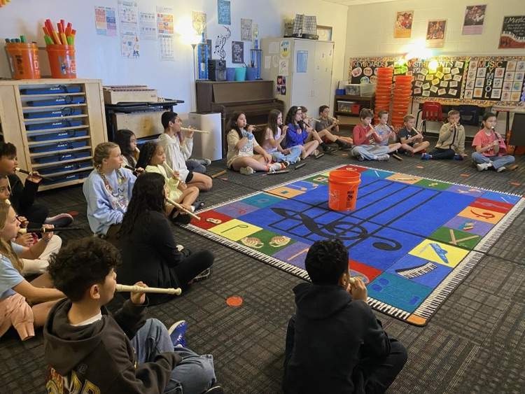 A group picture of students playing the recorder