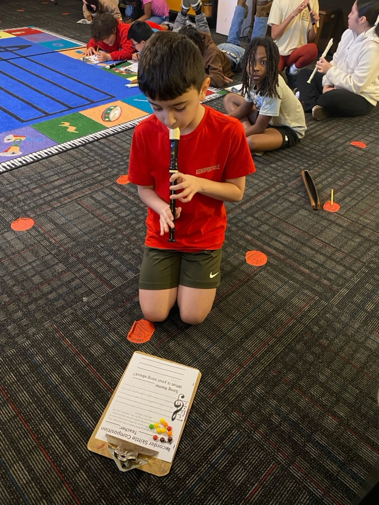 A student reading music and playing the recorder