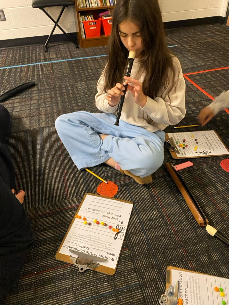 Student reading music and playing the recorder