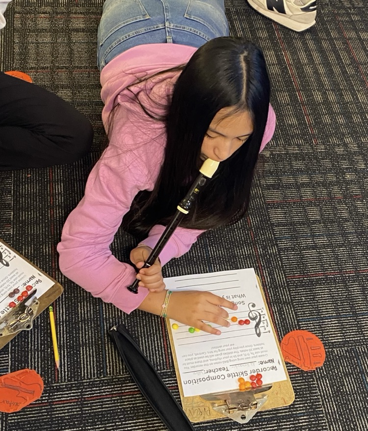 Student reading music and playing the recorder