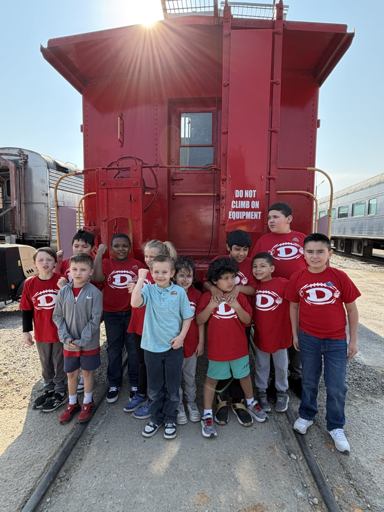 Students taking a picture in the back of the caboose 