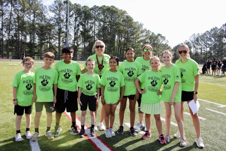 Students on the field with Mrs. King