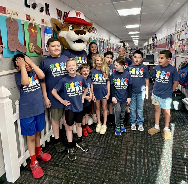 A group picture of students wearing the Autism Awareness shirt with Westie