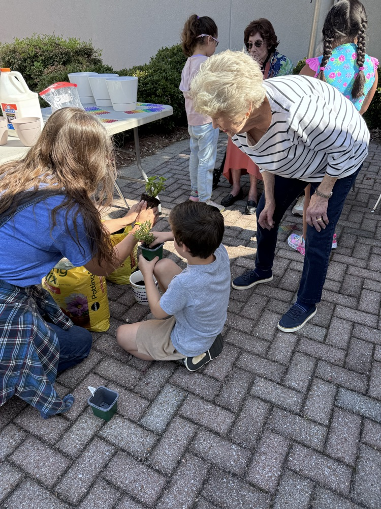 First grade students selecting a plant to plant with Royal Oaks friend