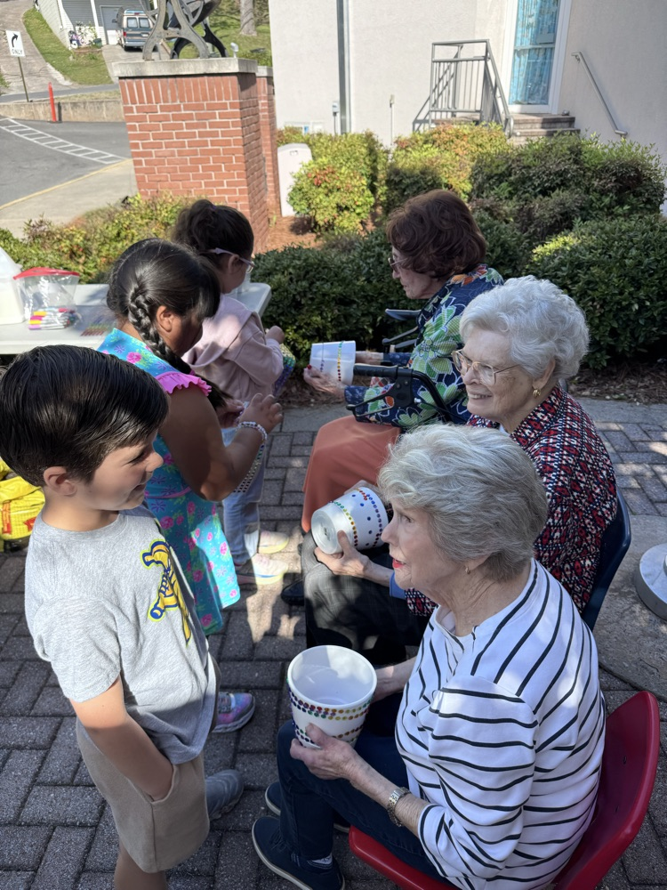 Students decorating pots with Royal Oaks friend