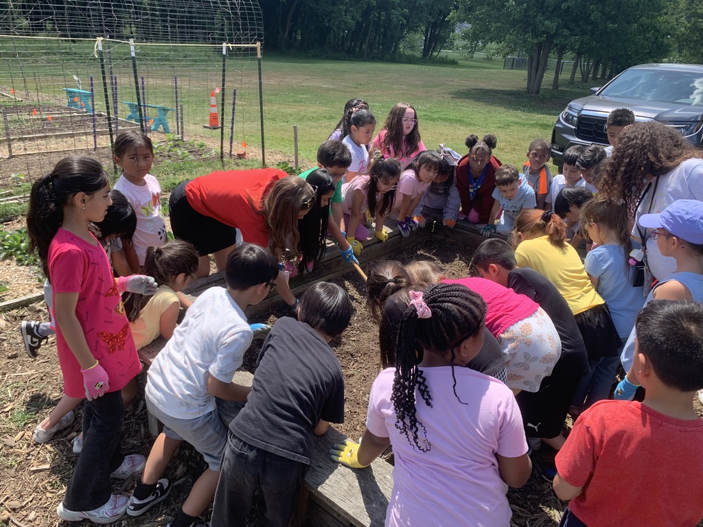 students cleaning out garden beds