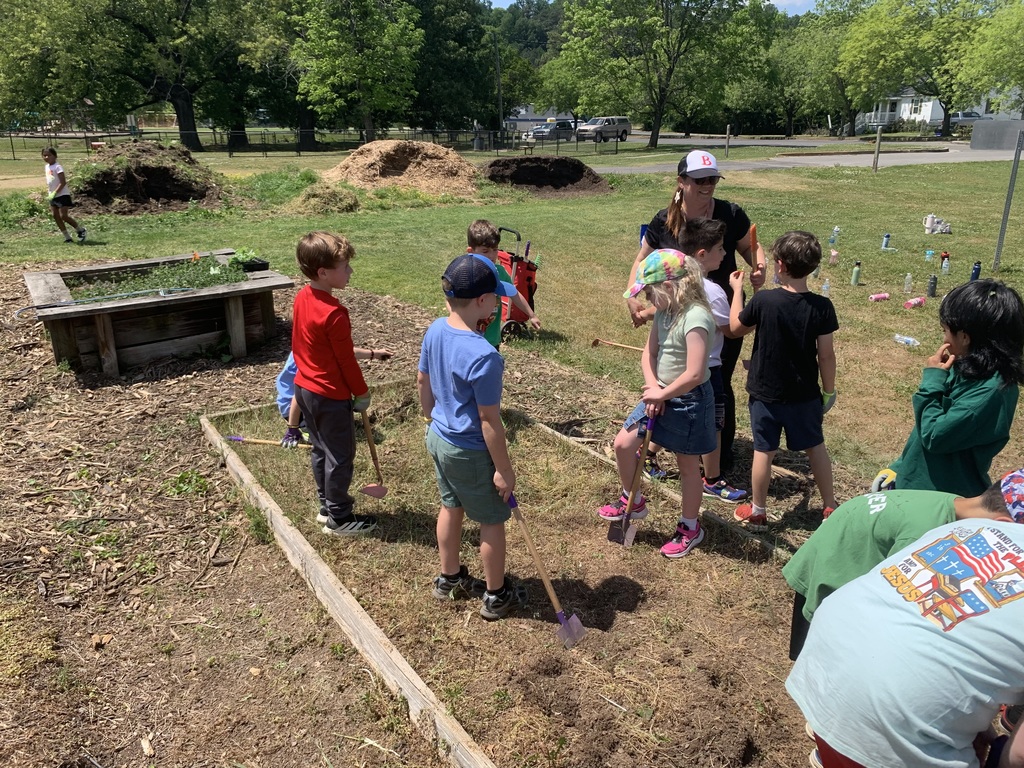 students cleaning out garden beds
