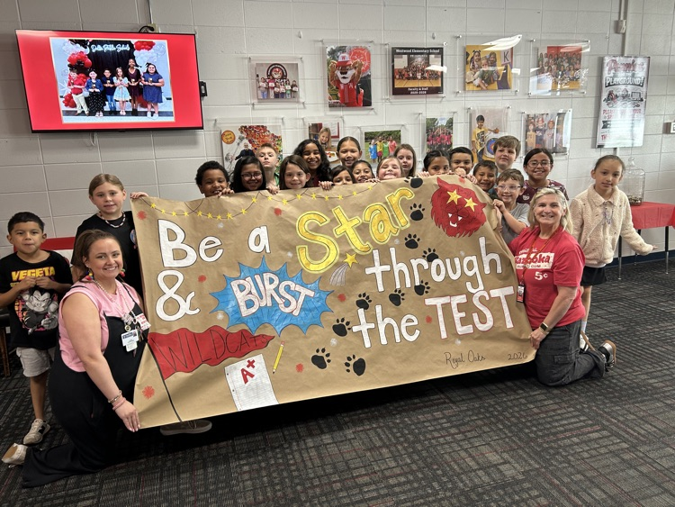 A picture of a group students, Ms. Pierce and Royal Oaks representative holding the testing sign they did for Westwood 