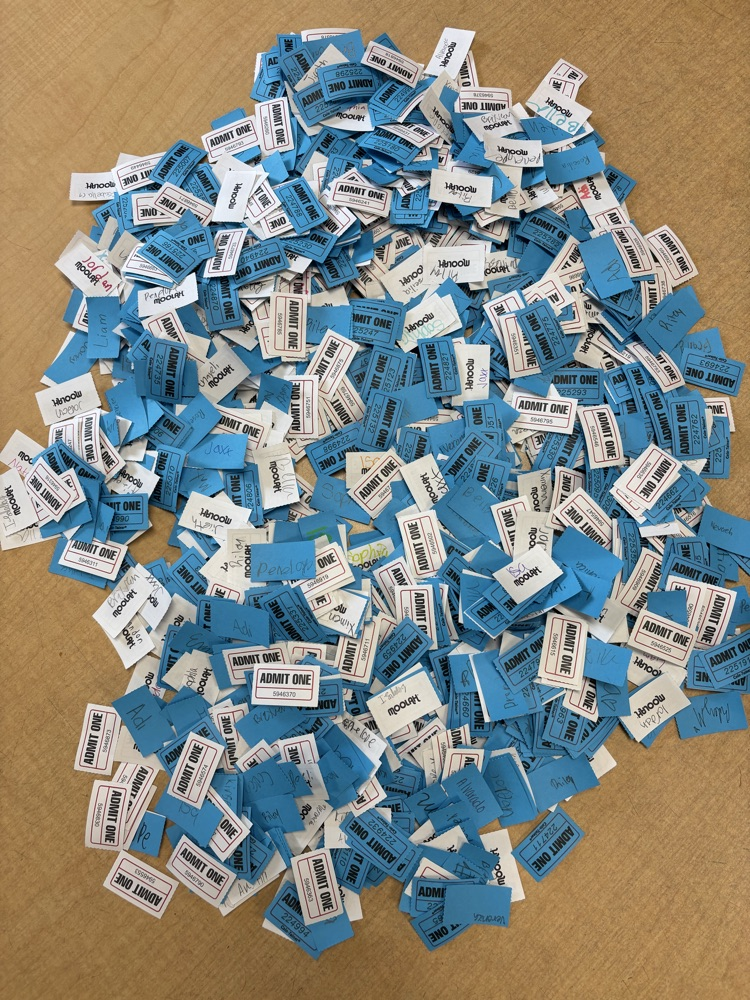 A picture of all the raffle tickets (white and blue) on the table 